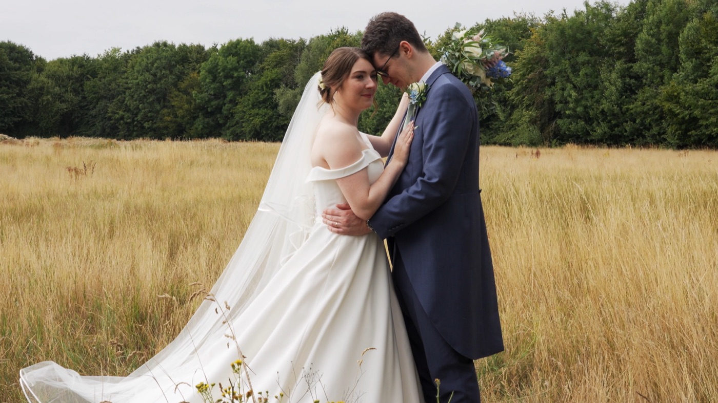 A bride and groom in a golden wheat field