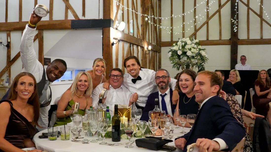 Guests laughing around a table at a celebration