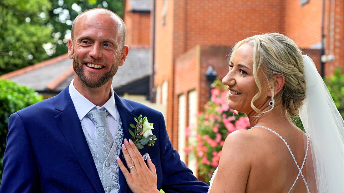 A groom and bride laughing together